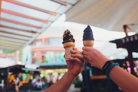 Hand holding chocolate triple scoop ice cream.の写真素材