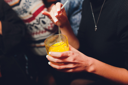Woman holding jar of orange juice, closeup.の写真素材