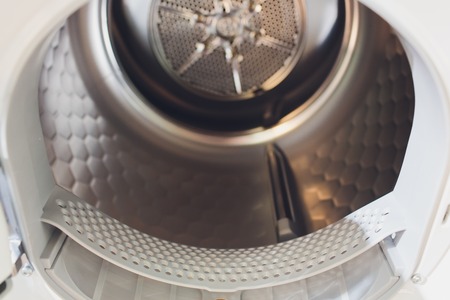 Washing machine drum interior, Internal view of an empty washing machine drum.の写真素材