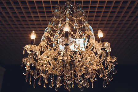 Close up on crystal of contemporary chandelier, is a branched ornamental light fixture designed to be mounted on ceilings or walls.の写真素材