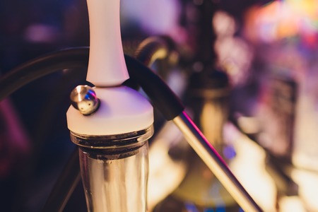 empty glass hookahs under the light of neon against the background of the restaurant. beautiful...