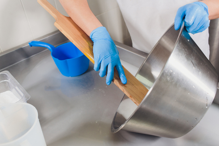 Traditional Cheese Making In A Small Company. Cheese Maker Hands Close-up Top View.の写真素材