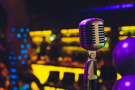 Retro microphone against blur colorful light restaurant backgroundの写真素材