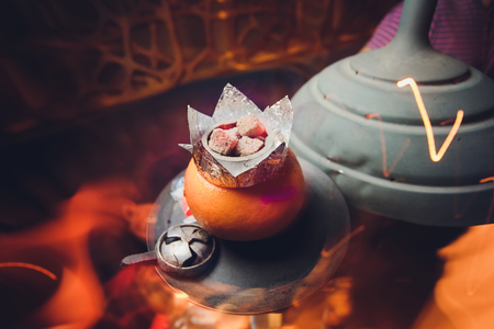 Luxury hookah with orange. Exotic bowl with fruit. Hookah lounge. Fruits and coals. Glamours relax....