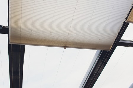 Wooden shutters on the window in the living room.の写真素材