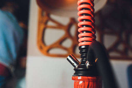 Trendy hookah with cloud of smoke against the background of the interior of the restaurant.の写真素材