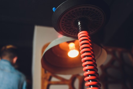 Trendy hookah with cloud of smoke against the background of the interior of the restaurant.の写真素材