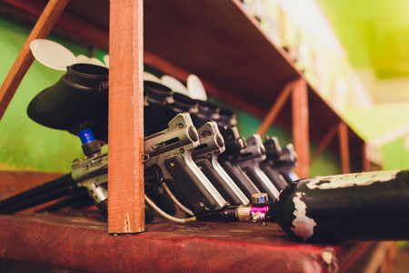 Paintball guns on a wooden table. play paintballの写真素材