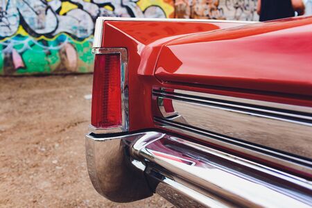 A closeup of the headlight and front bumper on a vintage car.の写真素材