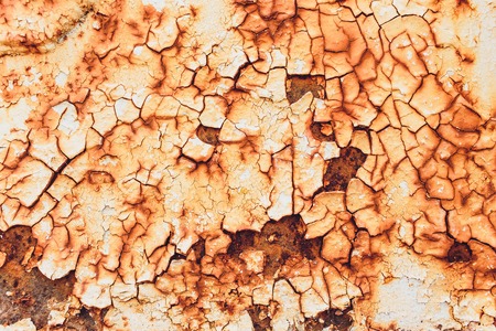 Rusted white painted metal wall. Rusty metal background with streaks of rust. Rust stains. The metal...