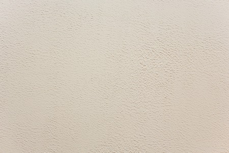 Classic manually applied beige exterior plaster texture, Ground fine light plaster, Outdoor fine grain plasterの写真素材