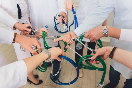 hand holding stethoscope on white background. medical groupの写真素材