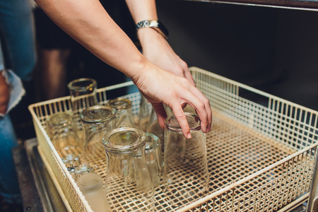 Glasses in a machine for doing dishesの写真素材