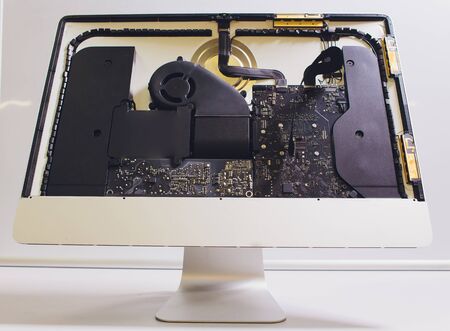 Process of computer repair. Engineer in white gloves disassembling computer