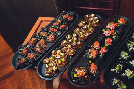 crackers with cream cheese and black caviar, horizontal.