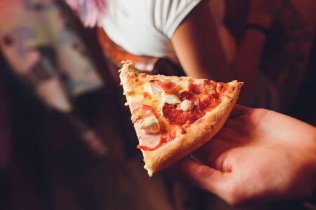 Slice of pizza cheese crust seafood topping sauce. with bell pepper vegetables delicious tasty fast food italian traditional and soft drink carbonated fresh on wooden board table classic.の写真素材