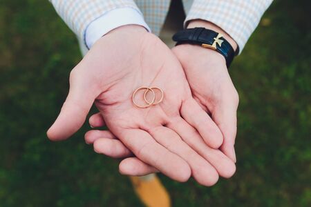wedding rings in the hand of the groom.の写真素材
