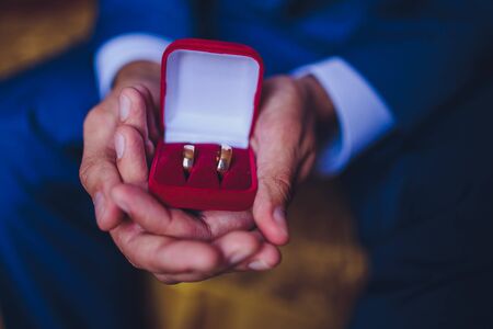 wedding rings in the hand of the groomの写真素材