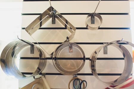 silicone and metal molds for cakes and cookies, paper cups, rolling pin dough krtspnym up on a white background baker tools.の写真素材