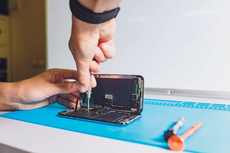 Close-up photos showing process of mobile phone repair.