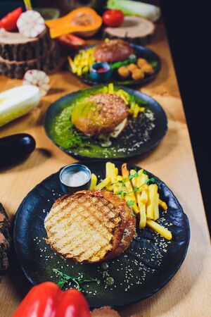 Red, green,black mini burgers with quinoa and vegetables.の写真素材