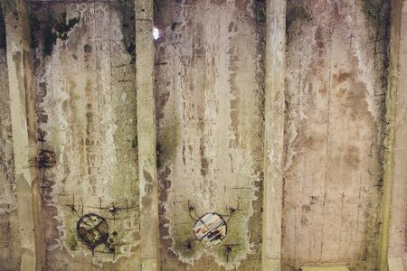 The destroyed big concrete building in a foggy haze. The remains of the frame of gray concrete piles and debris of the building structure. Background.の写真素材