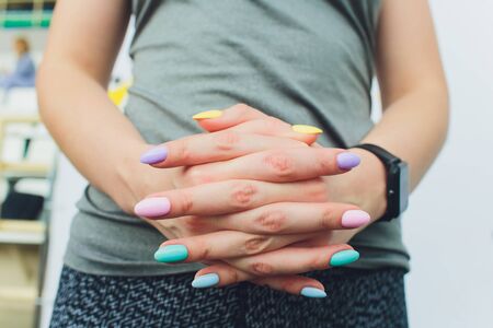 Womens hands. Fingers and multicolored nails, manicure. Beautiful female hands. Long nails...