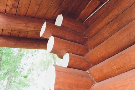 wooden wall from round logs close-up brown.の写真素材