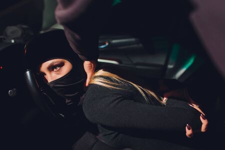 Masked robber woman car robbery found arrest.の写真素材