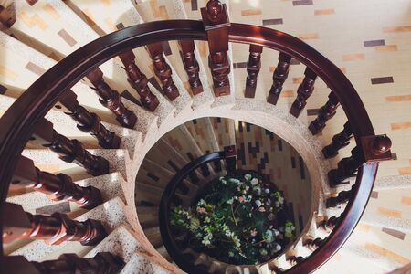 Yellow light in the center of spiral staircase.