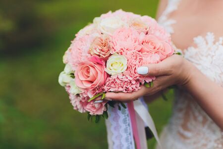 wedding bouquet in brides hands, david austin.