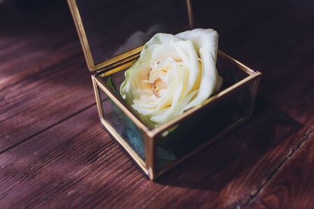 wedding rings in the box and a bouquet of the bride on the table.の写真素材