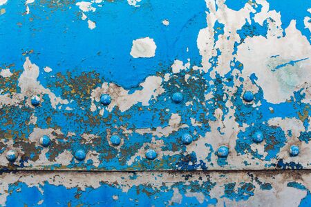 beautiful metal painted vintage background, blue with many small cracks, barely visible shades of orange under a layer of paint, close-upの写真素材