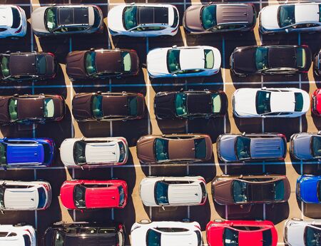 Top view of new cars lined up outside an automobile factory for import export.