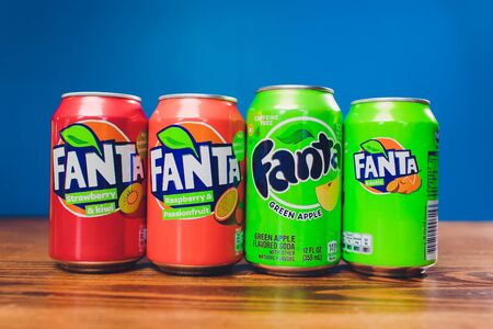 Ufa, Russia, 12 June, 2019: different cans of soft soda drink Fanta by coca-cola company at wooden table , product shotのeditorial素材