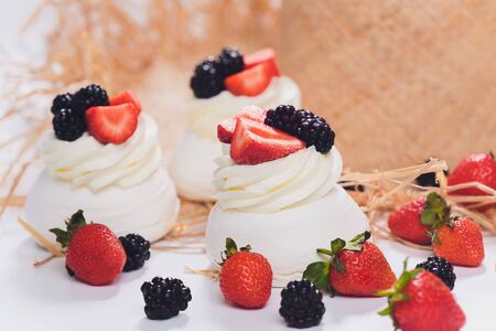 Dessert with berries on a meringue with cream.の写真素材