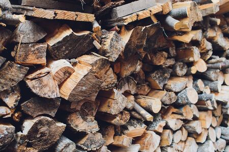 Pile of firewood. Preparation of firewood for the winter and use for cooking, firewood background,...
