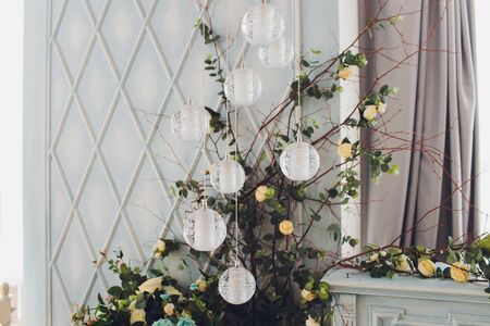 The wooden swing decorated with artificial flowers.の写真素材