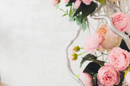 The wooden swing decorated with artificial flowers.の写真素材