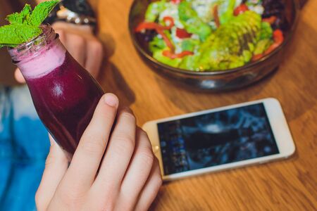 Vegetable salad with avocado, cucumber, cherry tomato, chard leaves and broccoli on a plate, on the wooden table.の写真素材