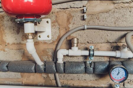 Closeup of manometer, pipes and faucet valves of heating system in a boiler roomの写真素材