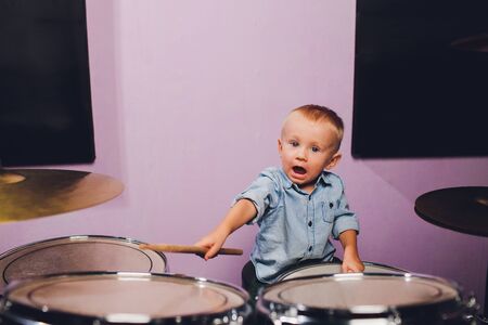 little boy plays drums in recording studio.の写真素材