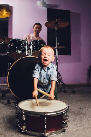 little boy plays drums in recording studio.の写真素材