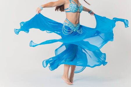 Portrait of belly dancer girl in blue. isolated on white.の写真素材