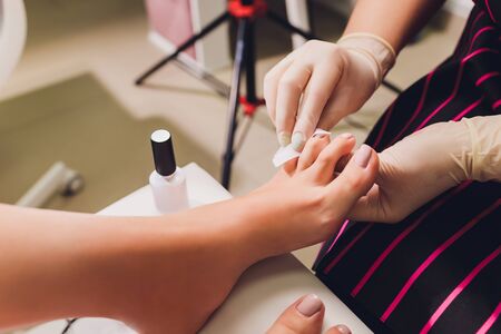 Young woman getting professional pedicure in beauty salon, closeup.の写真素材