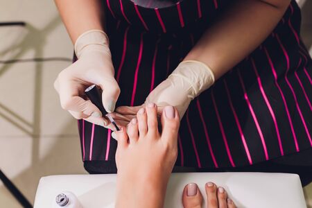 Young woman getting professional pedicure in beauty salon, closeup.の写真素材
