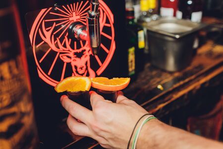 Ufa, Russia, HARATS PUB, 15 November, 2018: Jagermeister alcohol drinks in bar. bartender pours a glass.のeditorial素材