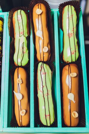 blue gift box with eclairs and macaroon.の写真素材