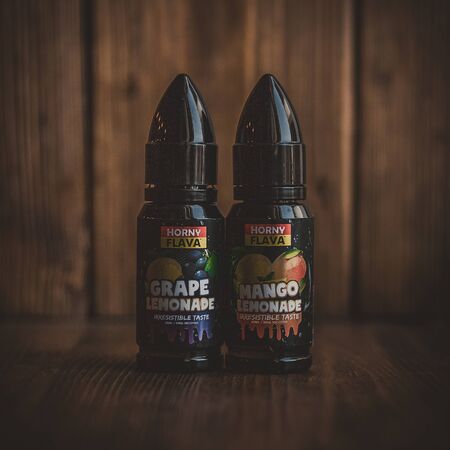 Ufa, Russia, Vape Shop, 1 July, 2019: E-liquid e-juice High vape for electronic cigarette vaping device , on counter in smoke vapor in vape bar in bottles.のeditorial素材