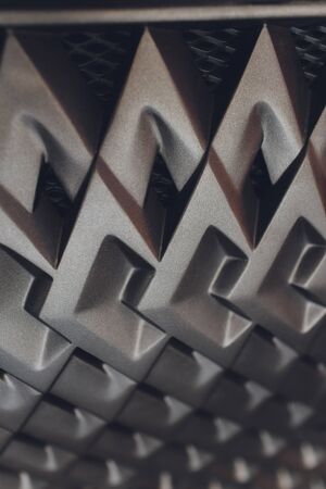 Grid of car with sunflare. Radiator grille. Metal close-up texture background. Chrome grill of big...